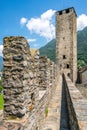 Scenic vertical view of Castelgrande castle tower taken from rampart walk and blue sky during summer in Bellinzona Switzerland