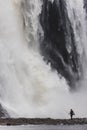 Scenic vertical view of a man fishing in the river next to the Montmorency Falls in Quebec, Canada Royalty Free Stock Photo