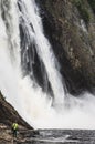 Scenic vertical view of a person near the river next to the Montmorency Falls in Quebec, Canada Royalty Free Stock Photo