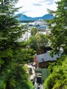 Scenic view from above Creek Street through luxuriant vegetation across town to port with cruise ship and distant mountains