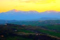 Scenic view from above at hills and mountains under the yellow sunset sky in Monte Vidon Corrado Royalty Free Stock Photo