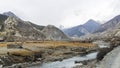 Scenic view along Annapurna Circuit trail near Braga with a suspension bridge over a river Nepal Royalty Free Stock Photo