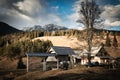 Scenic view in alpine forest mountains with isolated wooden chalet house in idyllic sunny winter environment, pokljuka, slovenia Royalty Free Stock Photo