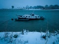 Scenic view of an anchored boat on a rippling water of Sava river during a gloomy and windy winter evening