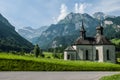 A scenic view of an ancient Holzkapelle church under the Alps mountains, in Grafenort, Switzerland.