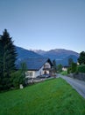 Scenic view of the Austrian village of Wolfurt against the backdrop of the Alps and green meadows. Vertical. Wolfurt, Austria Royalty Free Stock Photo