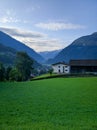 Scenic view of the Austrian village of Wolfurt against the backdrop of the Alps and green meadows. Vertical. Wolfurt, Austria Royalty Free Stock Photo