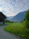 Scenic view of the Austrian village of Wolfurt against the backdrop of the Alps and green meadows. Vertical. Wolfurt, Austria Royalty Free Stock Photo