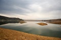 Scenic view of the Azat reservoir in Armenia with the reflection of small hills and a mountain range