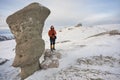 Scenic view of the Babele rocks in the Bucegi mounatins during winter with a young gril climber.