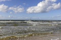 Scenic view of the Baltic Sea, rough water and waves, blue sky with white clouds, Miedzyzdroje, Poland Royalty Free Stock Photo