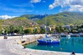 Scenic view of the bay and pier Loutraki, Greece, where small fishing schooners, yachts, boats and boats moored in the clear
