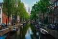 Scenic view of beautiful buildings along a river in Amsterdam, Netherlands