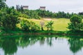 Scenic view beautiful golf course pond castle background view green lawn forest Reflection trees bush lush in water Royalty Free Stock Photo