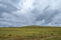 Scenic view of beautiful green hills and mountains with stormy cloudy sky on Olkhon island, Russia. Copy space. Royalty Free Stock Photo