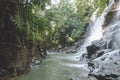 scenic view of beautiful Kanto Lampo Waterfall, green plants and rocks,