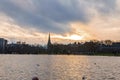 Beautiful lake with St Mary Abbots church and Kensington Palace during sunset Royalty Free Stock Photo