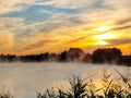 Scenic view of beautiful sunrise or dawn above the pond or lake at spring or early summer morning with cloudy sky Royalty Free Stock Photo