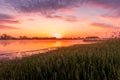 Scenic view of beautiful sunrise or dawn above the pond or lake at spring or early summer morning Royalty Free Stock Photo