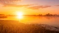 Scenic view of beautiful sunrise or dawn above the pond or lake at spring or early summer morning. Royalty Free Stock Photo