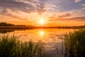 Scenic view of beautiful sunset or sunrise above the pond or lake at spring or early summer evening Royalty Free Stock Photo