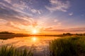 Scenic view of beautiful sunset or sunrise above the pond or lake at spring or early summer evening Royalty Free Stock Photo