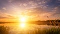 Scenic view of beautiful sunset or sunrise above the pond or lake at spring or early summer evening. Royalty Free Stock Photo