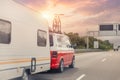 Scenic view big modern white family rv camper van vehicle driving on european highway road against sunset sun sky summer Royalty Free Stock Photo