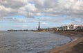 Scenic view of blackpool from the south with waves breaking on the steps, people on the promenade and the golden mile and tower in Royalty Free Stock Photo