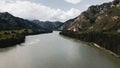 Scenic view of blue water river and forceful mountains. Drone footage Royalty Free Stock Photo