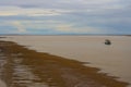 Scenic view of a boat on the Mudflats at Derby Wharf, Western Australia on a cloudy afternoon