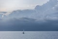 Scenic view of a boat sailing off the coast of cape cod at sunset under a dark stormy sky Royalty Free Stock Photo
