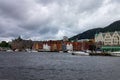 Scenic view of Boats and the facade of the historical buildings in Bergen, Norway on a gloomy day Royalty Free Stock Photo