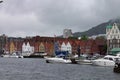 Scenic view of Boats and the facade of the historical buildings in Bergen, Norway on a gloomy day Royalty Free Stock Photo