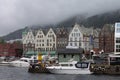 Scenic view of Boats and the facade of the historical buildings in Bergen, Norway on a gloomy day Royalty Free Stock Photo