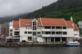 Scenic view of Boats and the facade of the historical buildings in Bergen, Norway on a gloomy day Royalty Free Stock Photo