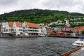 Scenic view of Boats and the facade of the historical buildings in Bergen, Norway on a gloomy day Royalty Free Stock Photo