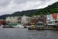 Scenic view of Boats and the facade of the historical buildings in Bergen, Norway on a gloomy day Royalty Free Stock Photo