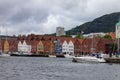 Scenic view of Boats and the facade of the historical buildings in Bergen, Norway on a gloomy day Royalty Free Stock Photo