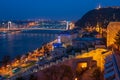 Scenic view of Budapest city at blue hour with illuminated Buda Castle, Citadella on Hellert Hill and Danube embankment Royalty Free Stock Photo