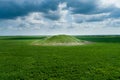 Scenic view of the burial mound of the Scythian king in a green field. Aerial view Royalty Free Stock Photo