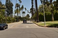 Scenic view of busy traffic driving down Beverly Hills on a sunny day