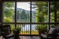 a scenic view of a calm lake from a cozy porch