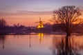 Scenic view of a calm waters with luminated old windmill in the background Royalty Free Stock Photo