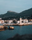 Scenic view of Cassis Lighthouse with the cityscape and mountains in the background. France Royalty Free Stock Photo