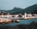 Scenic view of Cassis Lighthouse with the cityscape and mountains in the background. France Royalty Free Stock Photo