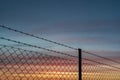 Scenic view of chainlink fence against a beautiful sunset sky Royalty Free Stock Photo