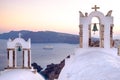 Scenic view of church roofs and cruise ship on Santorini