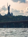 Scenic view of the city of Kyiv with the Motherland Mother Monument and a bridge in the foreground