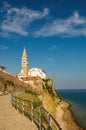 Scenic view of coastline of Adriatic sea with alley along Piran old city walls and cathedral on background, Slovenia